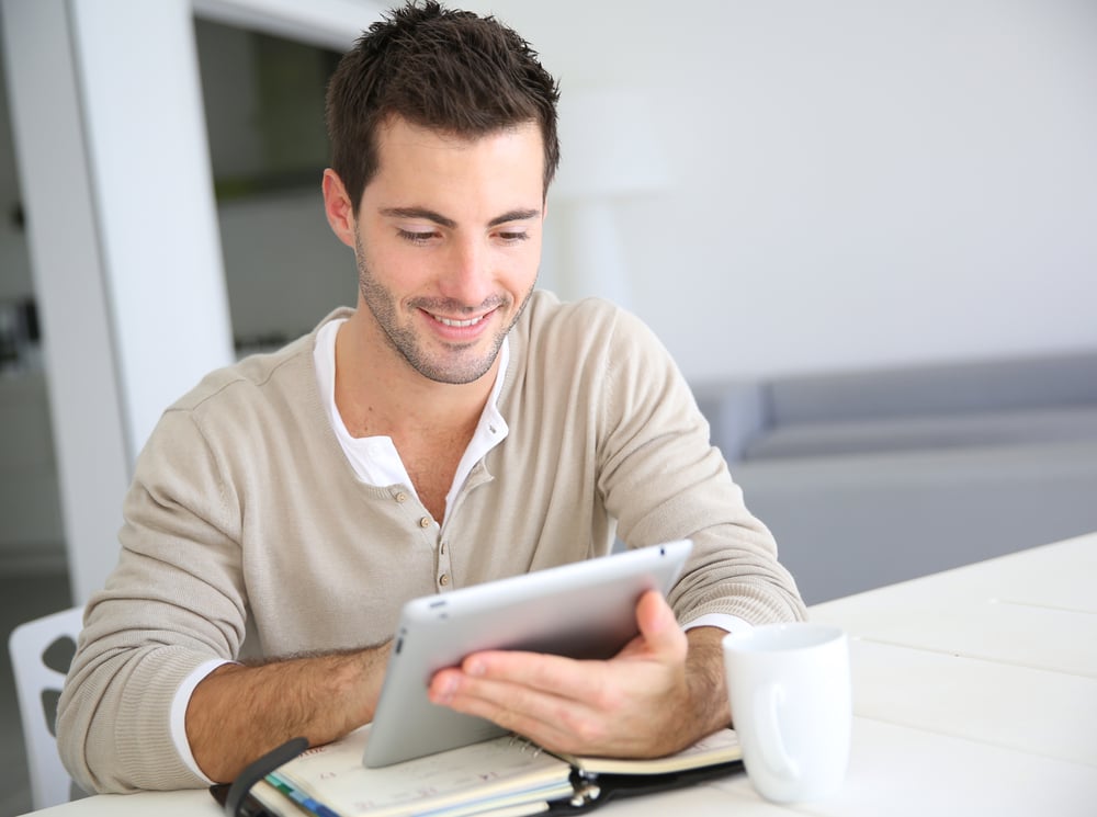 Man working from home on digital tablet